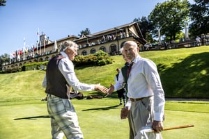 Hickory golfers greeting each other on the green in front of the Villa d’Este clubhouse after completing a hole.