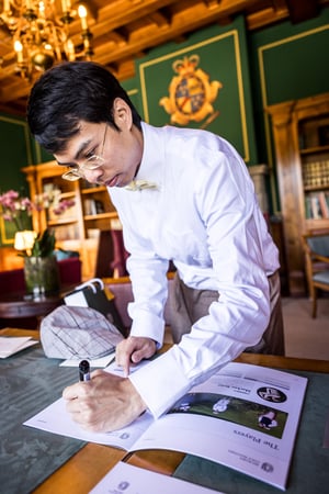 Hickory golf player signing the official players booklet before the tournament at the clubhouse.