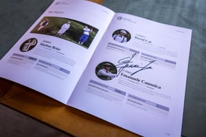 Open players' booklet featuring competitor profiles and signatures for the Hickory Golf Masters tournament.