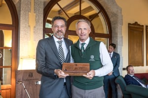 Senior category winner receiving The Hickory Masters handcrafted wooden trophy during the awards ceremony.