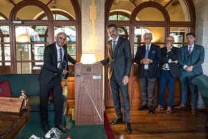 The winner of the first Hickory Masters in 2026, together with the organizers, standing next to the wooden scoreboard featuring an original hickory bat, on which his name has been inscribed