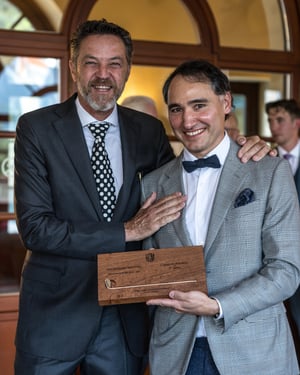 Amateur category champion posing with The Hickory Masters wooden trophy after the awards ceremony.