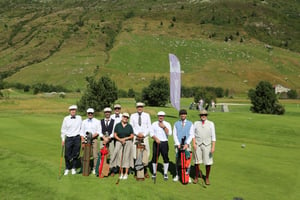 Participants in the 2026 Hickory Golf Masters Tour pose together on the golf course in traditional golf attire, holding vintage clubs and bags.